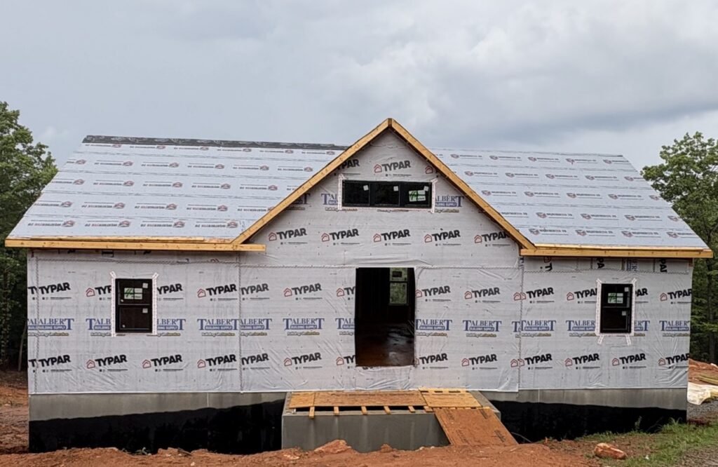 Broomtail Lane custom home during framing stage wrapped in Typar house wrap before siding