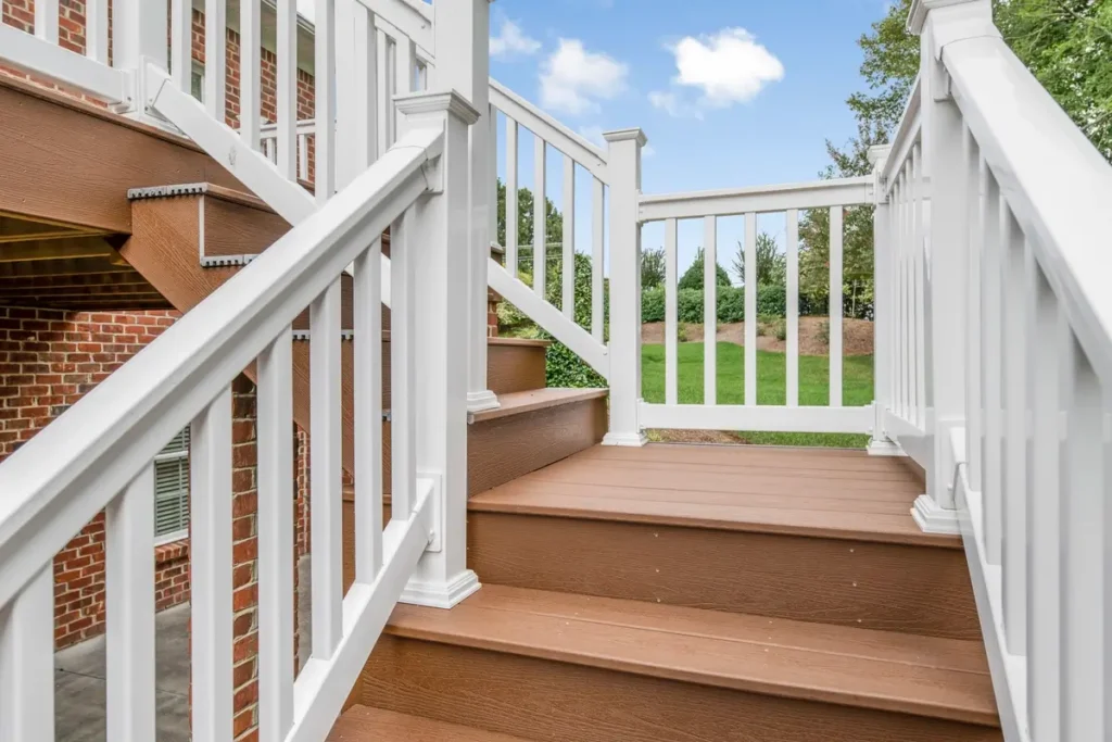 Looking up Turnstone Court deck staircase toward composite treads and white railing landing