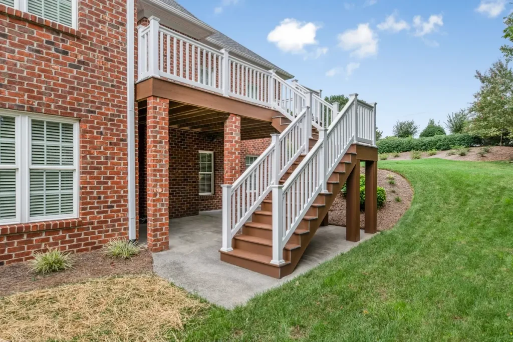Turnstone Court back deck stairway with white balusters leading to brick pier supports