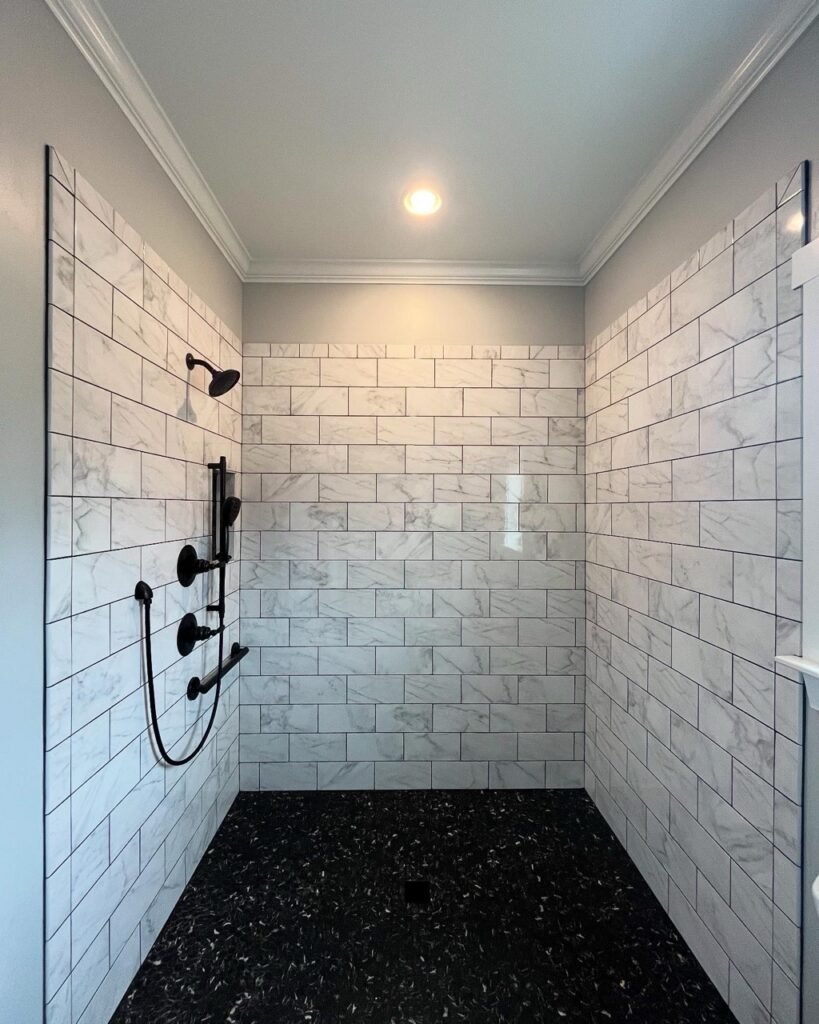 Marble subway tile walk-in shower with dark oil-rubbed fixtures in the in-law suite bathroom addition