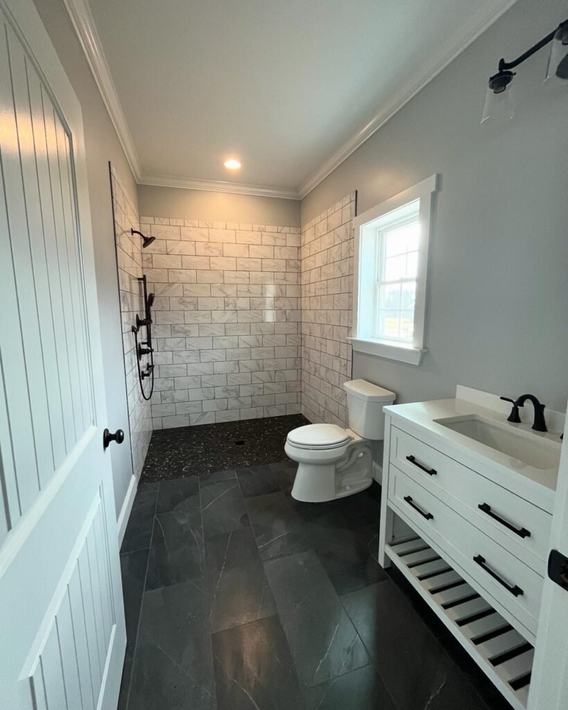 Wide view of in-law suite bathroom showing walk-in shower, vanity and window at Lavender Farm Trail