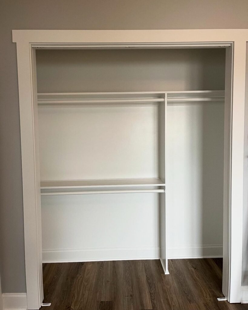 Bedroom closet with double hanging rods and shelf inside the Lavender Farm Trail addition