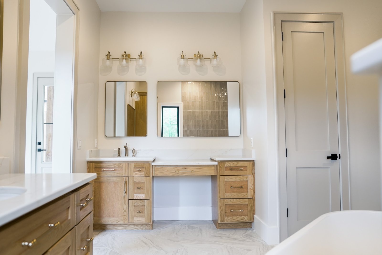 Primary bath double vanity with white oak cabinetry
