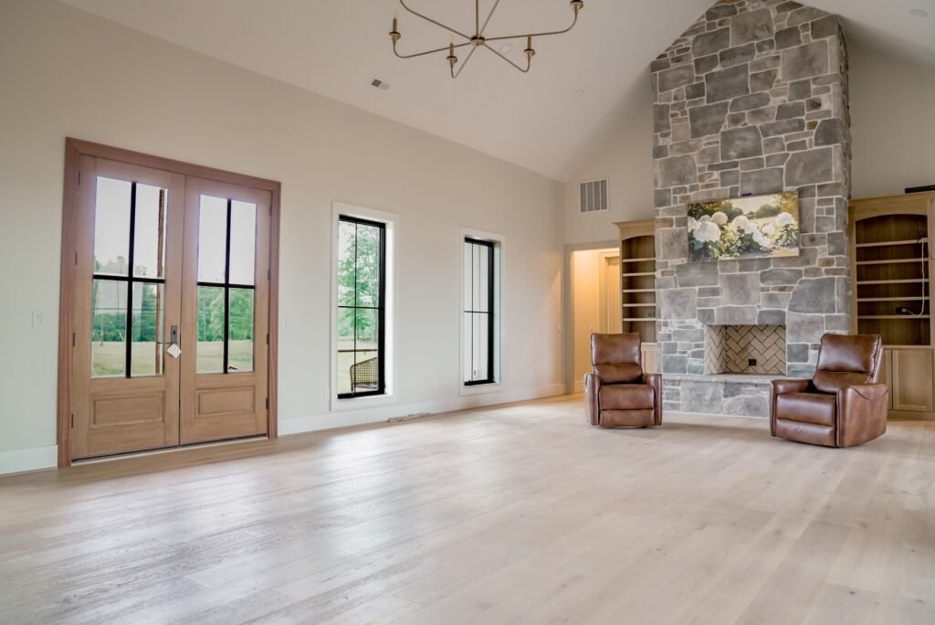 Vaulted great room with a floor-to-ceiling stone fireplace in the Jack Davis custom home