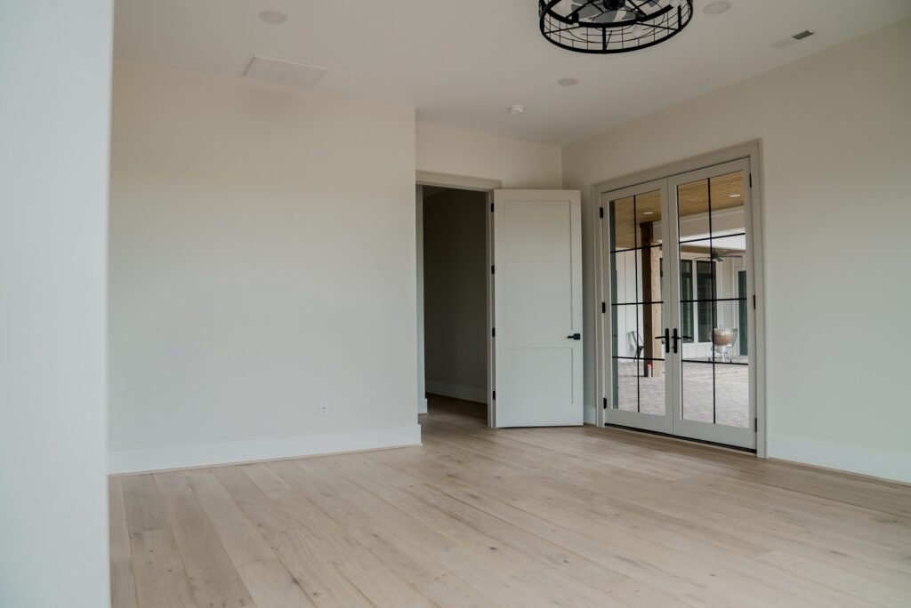 Vaulted great room with a floor-to-ceiling stone fireplace in the Jack Davis custom home