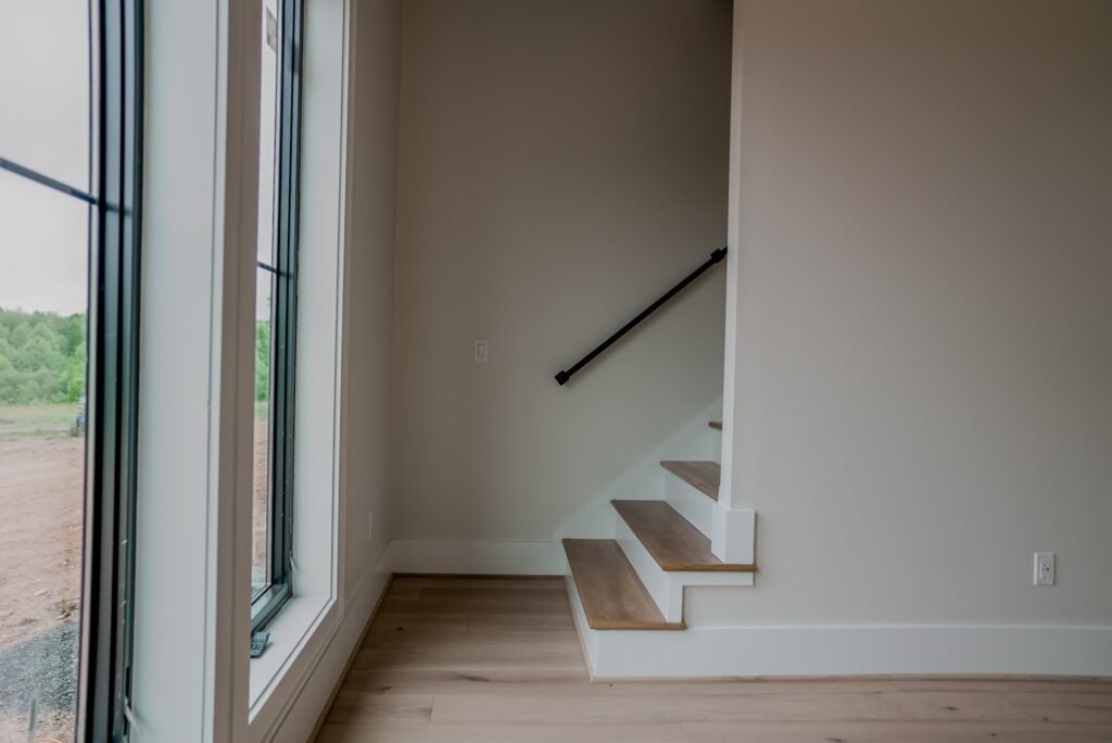 Open-riser staircase with white oak treads in the Jack Davis custom home