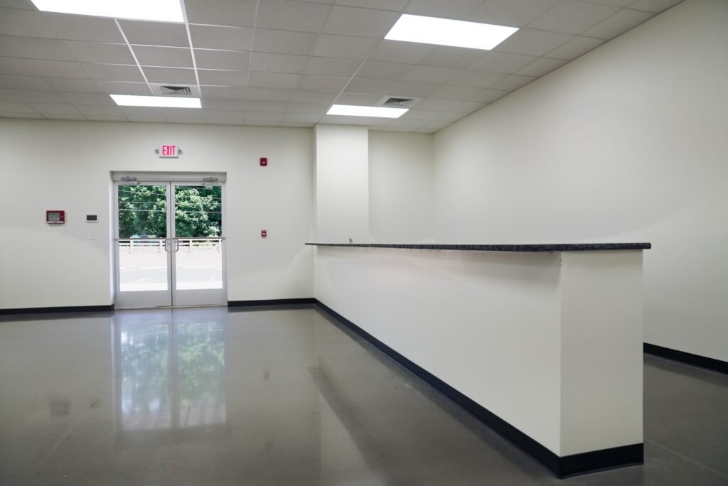 Reception area with a service counter and glass entry doors