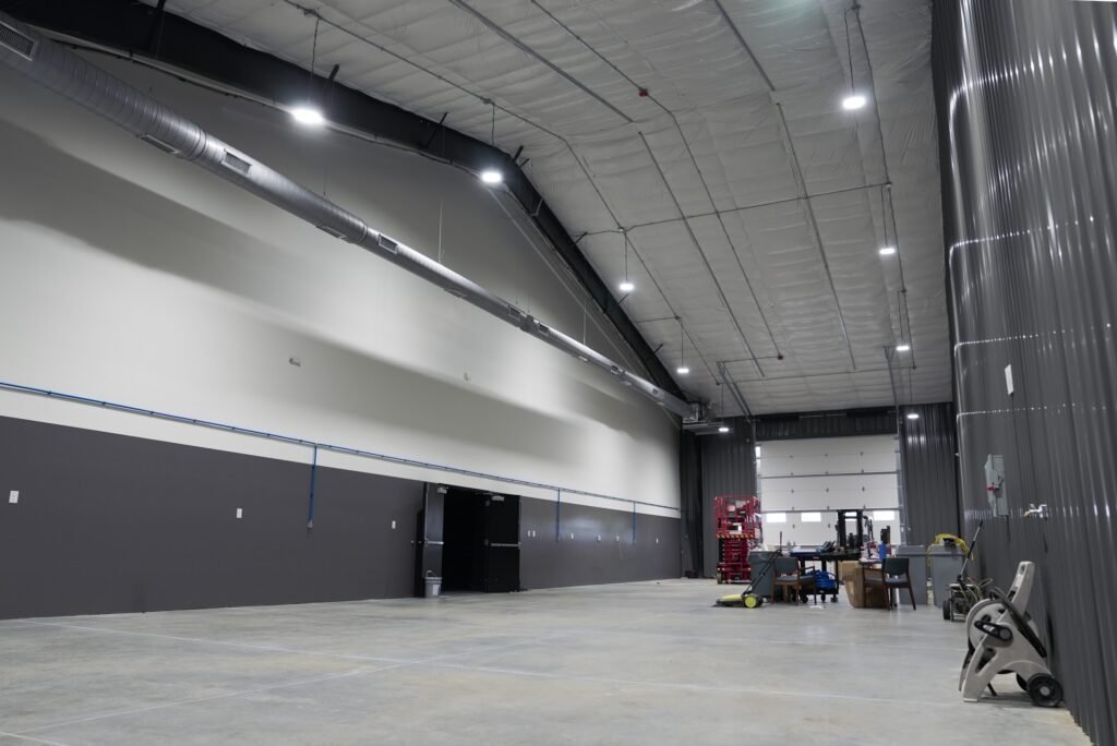 Equipment bay with dark metal walls and industrial lighting
