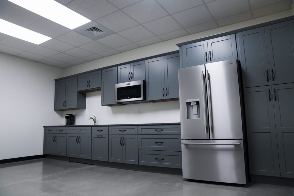 Employee breakroom with gray cabinetry and stainless appliances