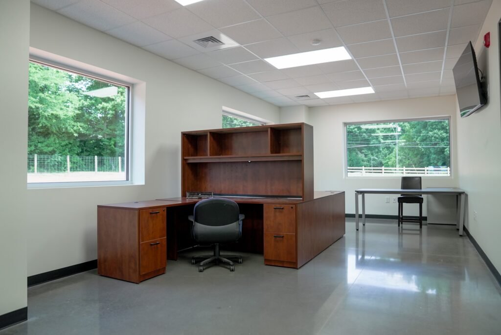 Private office with a built-in desk and natural light