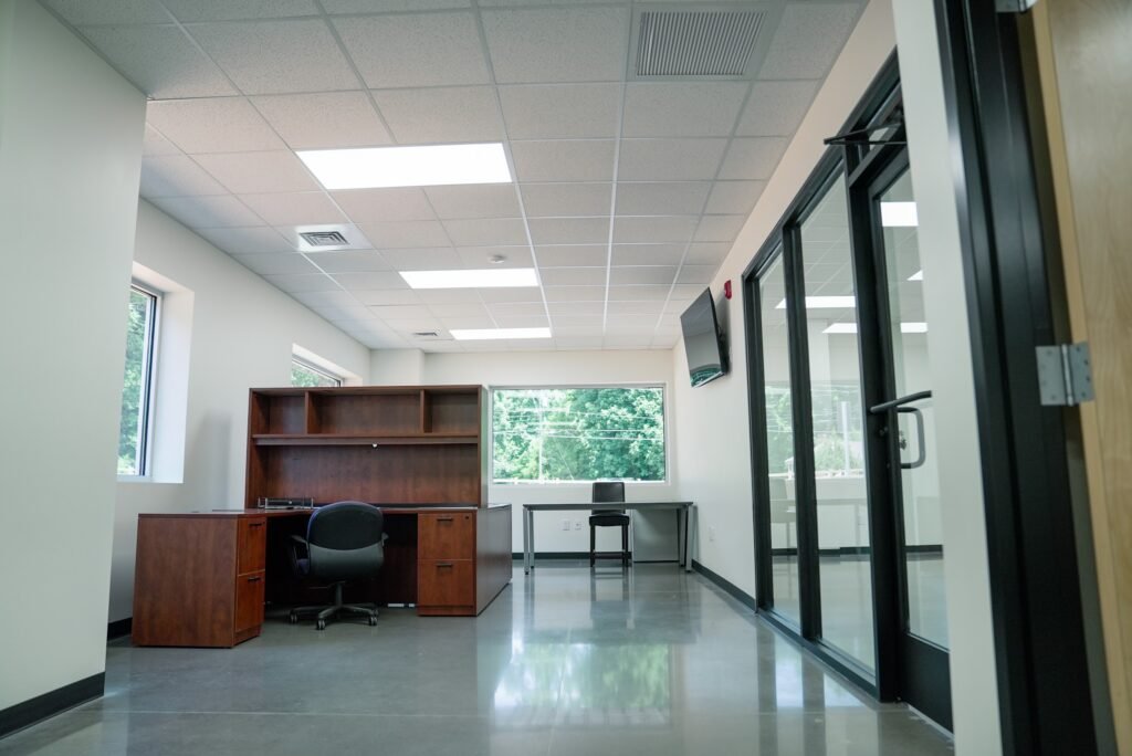 Office corridor lined with glass-walled offices