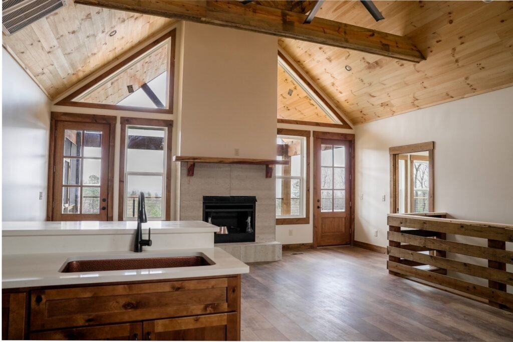 Great room with a vaulted tongue-and-groove ceiling and stone fireplace