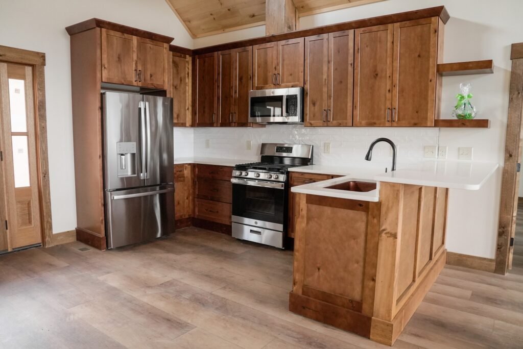 Kitchen with stained wood cabinetry, stainless appliances and a center island
